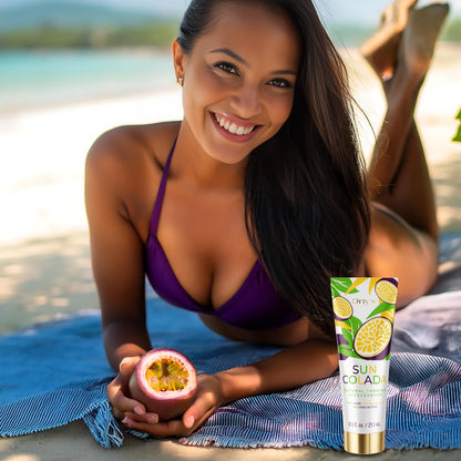 Smiling woman in purple bikini lying on a beach towel with passion fruit and Onyx Suncolada Accelerator sunbed cream, showing smooth glowing skin and natural tan results.